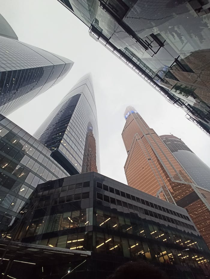 Striking low-angle photo of towering skyscrapers in Moscow, showcasing modern architecture and urban design.