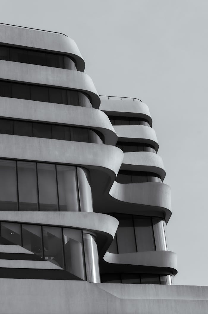 Black and white photo of a modern building with wavy architectural design elements.